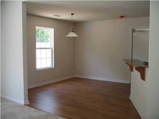5216 Moore Loop Crestview, FL 32536 - Photo 3 of 5 a view of a room with wooden floor and windows