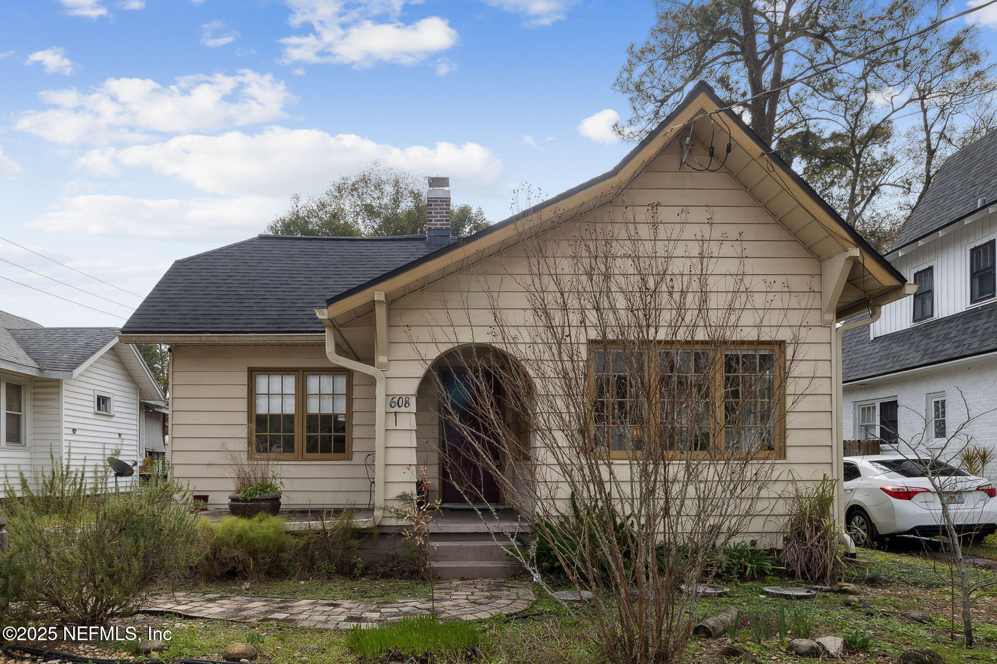a front view of a house with garden