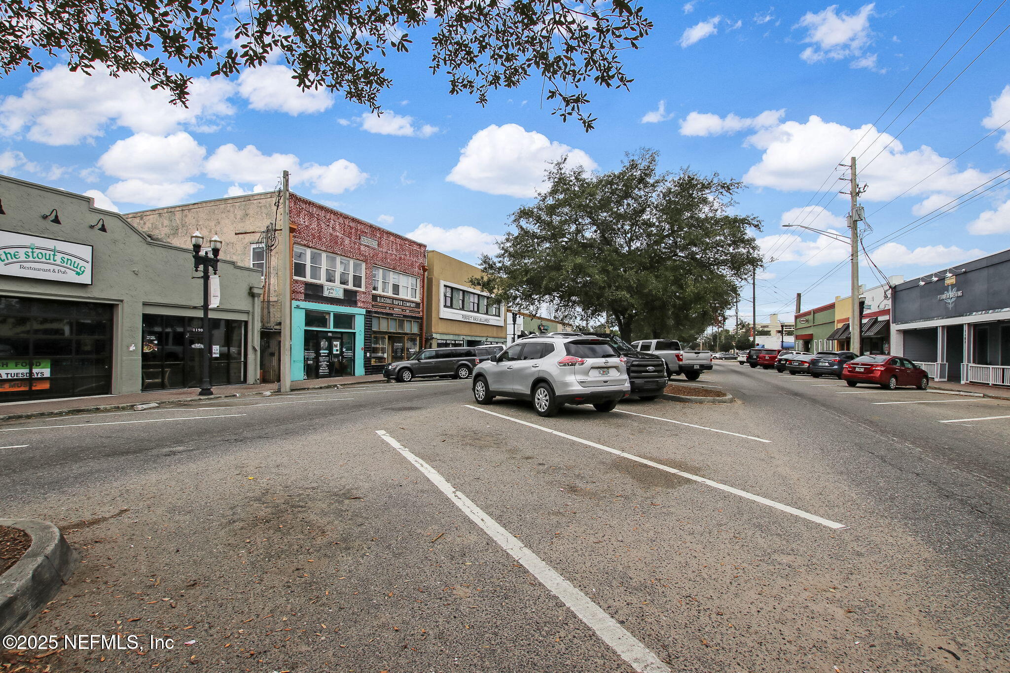 4608 Post Street Jacksonville, FL 32205 - Photo 41 of 49 a view of road with card parked on side and retail shops