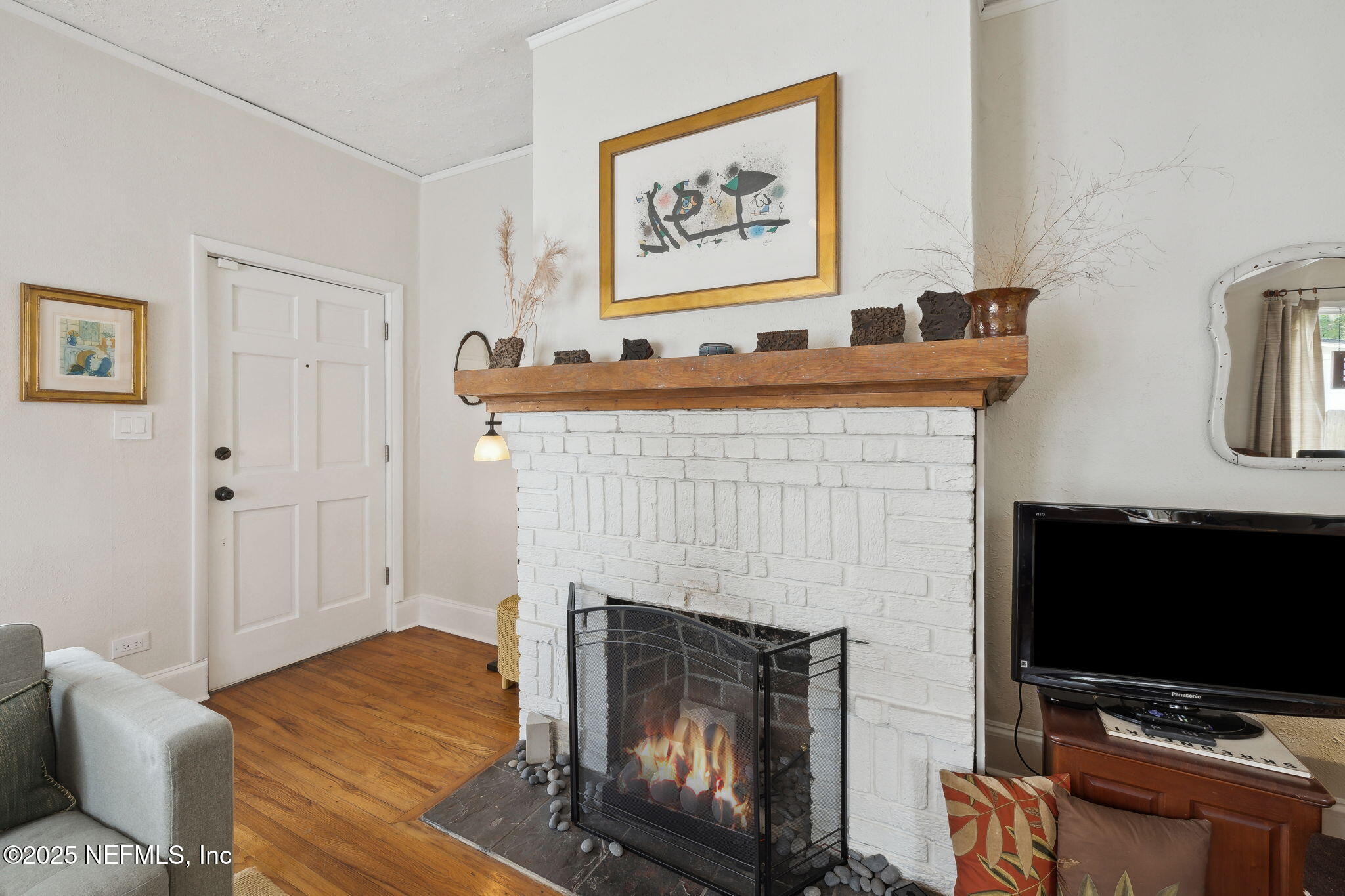 4608 Post Street Jacksonville, FL 32205 - Photo 10 of 49 a living room with furniture a flat screen tv and a fireplace