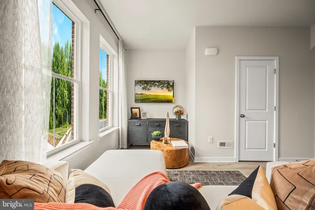 a bedroom with a bed and glass window