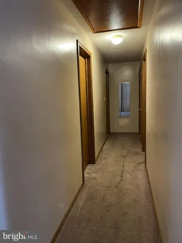 a view of empty room with wooden floor and closet