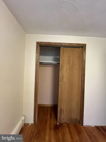 a bedroom with a bed and a wall painting