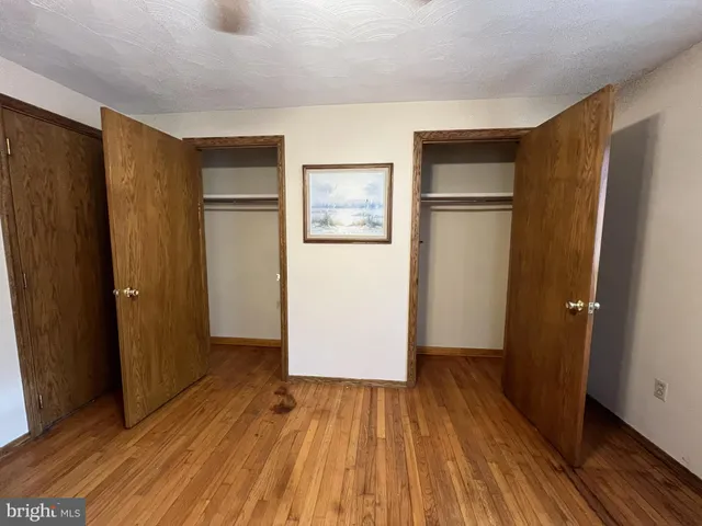 a bathroom with a granite countertop sink a toilet and a shower