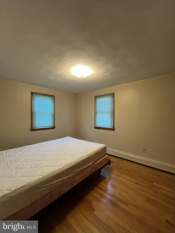 a view of workspace with lots of furniture and windows