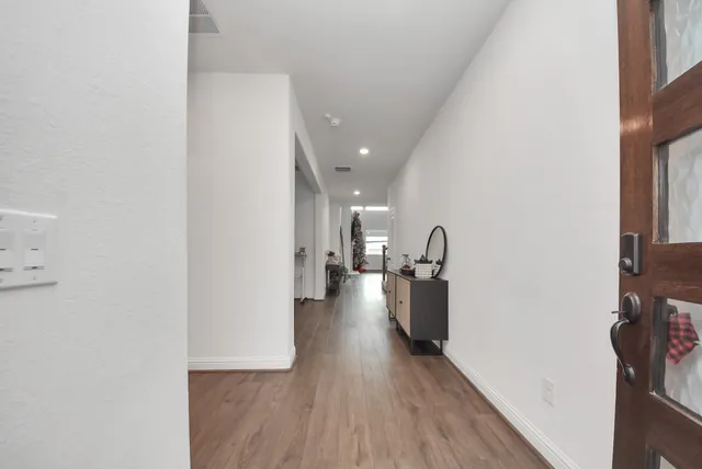 a view of a living room with furniture and a ceiling fan