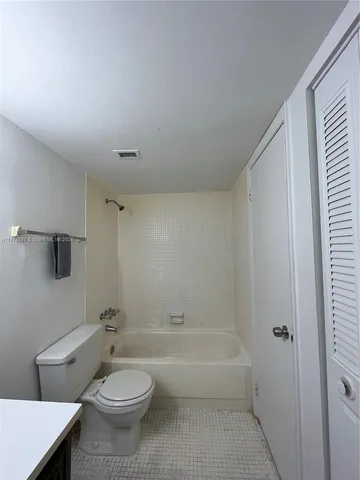 a bathroom with a toilet a sink and a bathtub