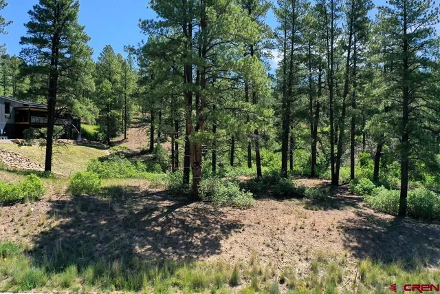 an aerial view of residential houses with outdoor space and street view