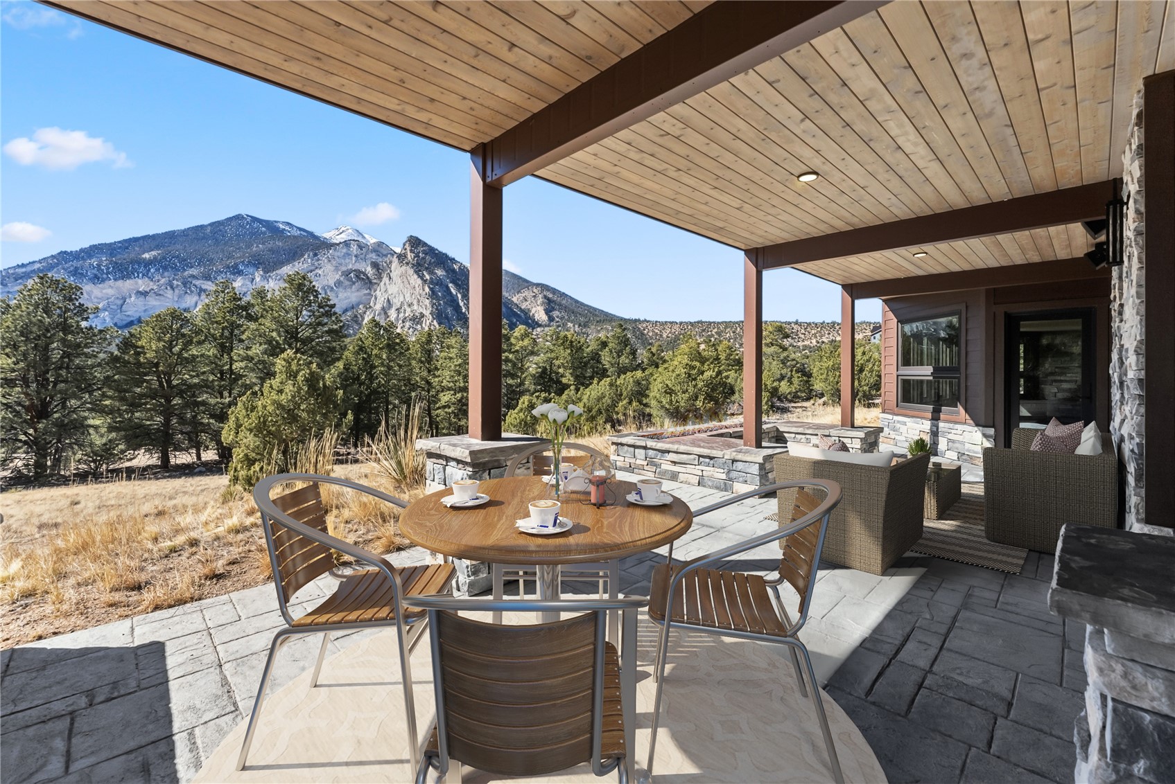 21261 Broadview Road Nathrop, CO 81236 - Photo 46 of 49 a view of a patio with a dining table and chairs with wooden floor and fence