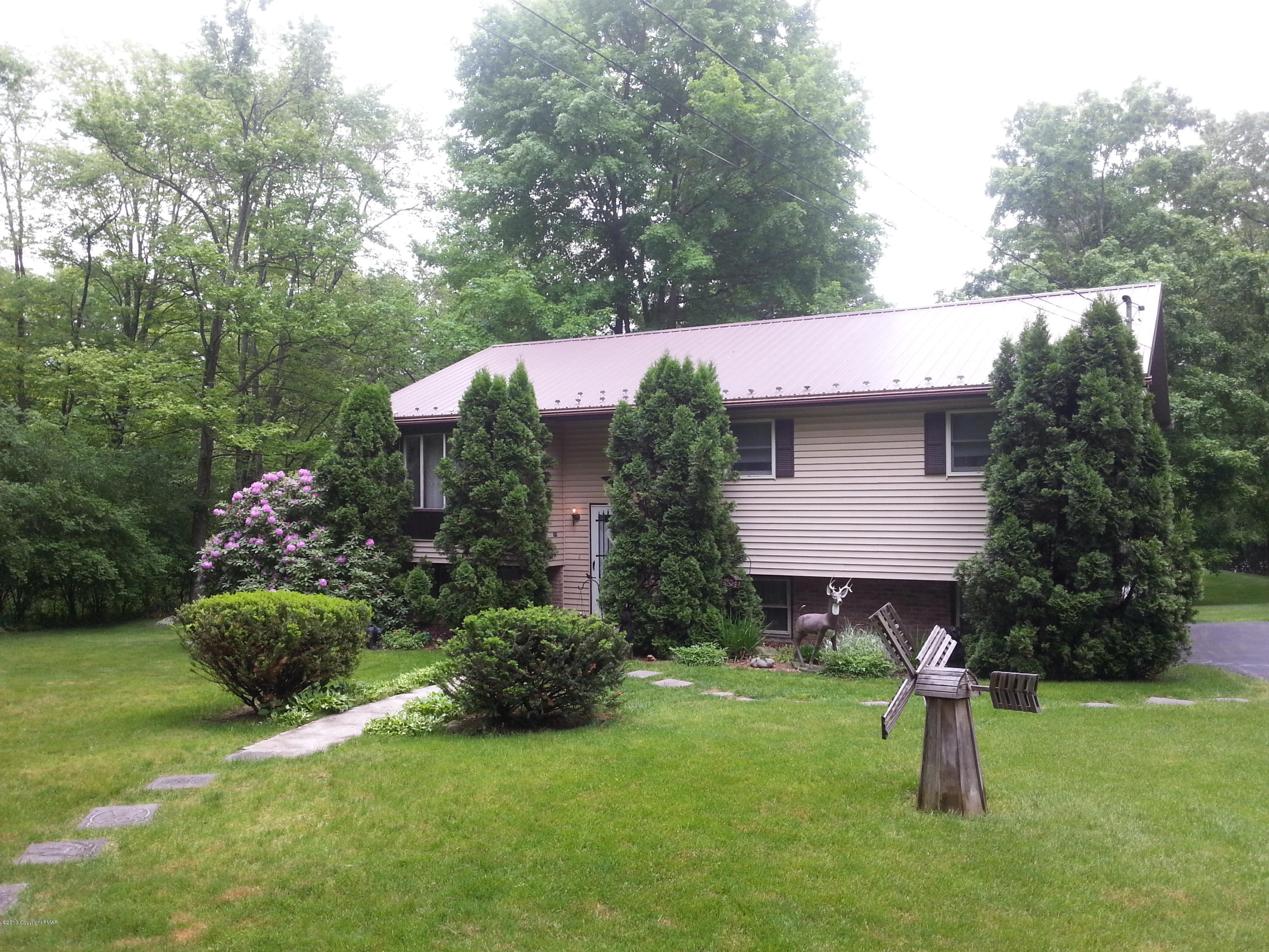 2187 Shafer Road Stroudsburg, PA 18360 - Photo 1 of 29 a backyard of a house with barbeque oven table and chairs