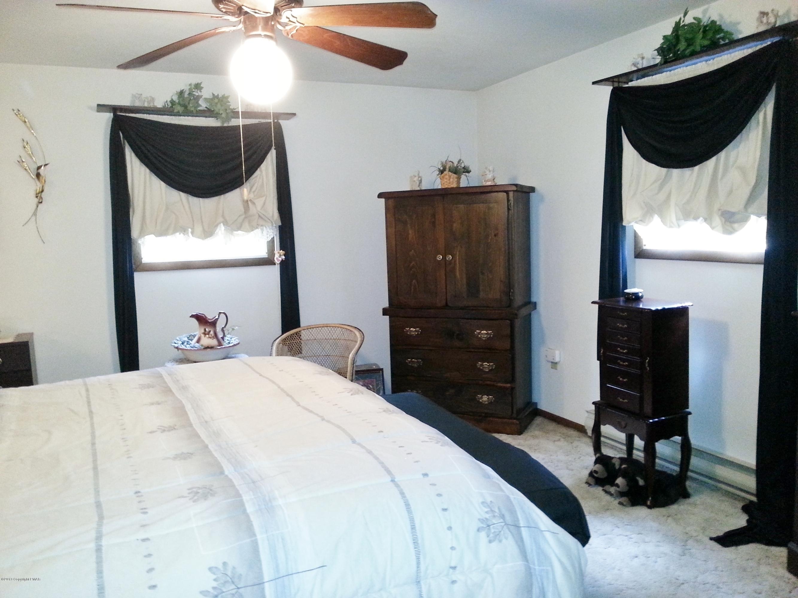 2187 Shafer Road Stroudsburg, PA 18360 - Photo 12 of 29 a bedroom with a bed and a chandelier