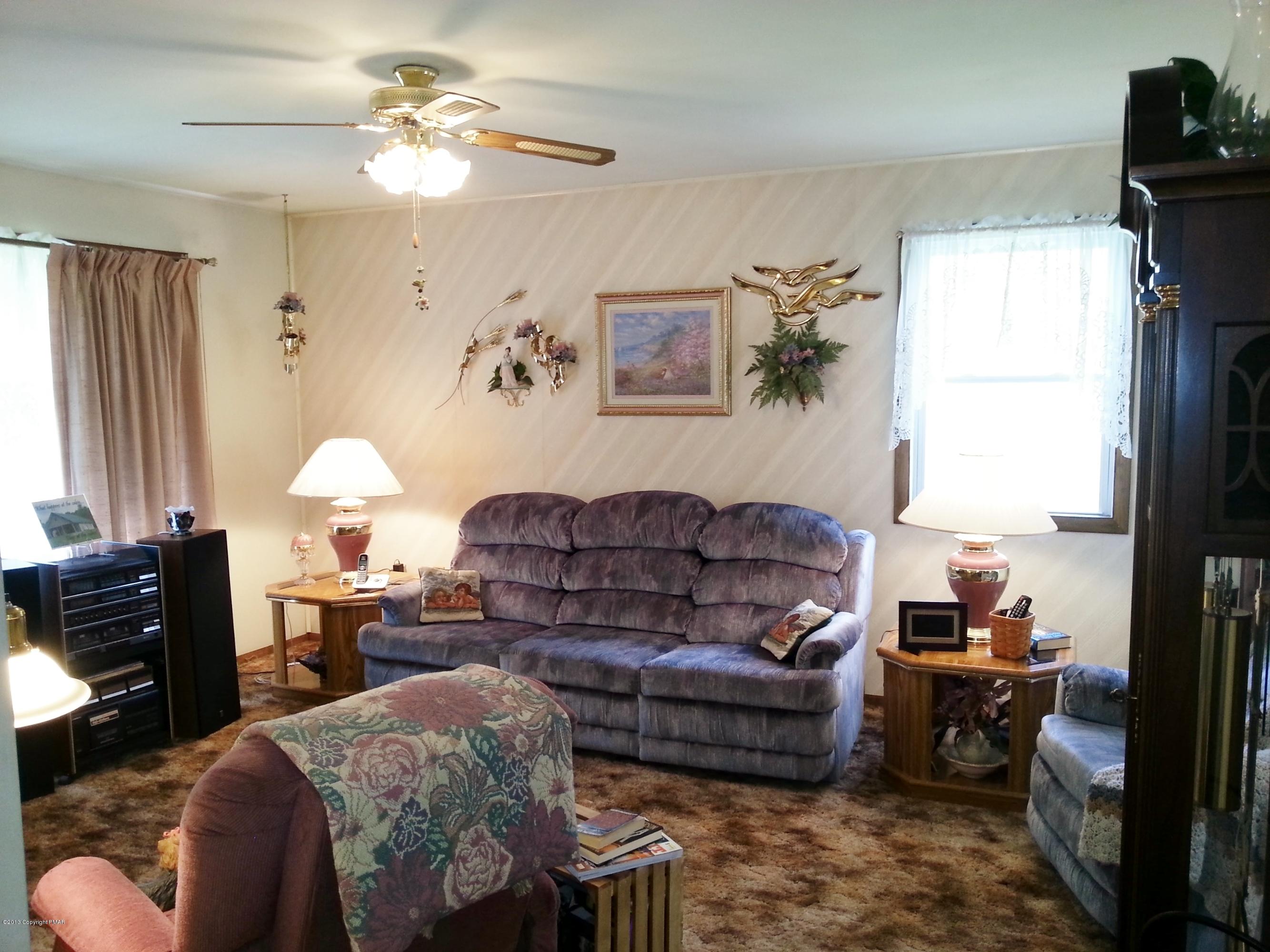 2187 Shafer Road Stroudsburg, PA 18360 - Photo 3 of 29 a living room with furniture a chandelier and a window