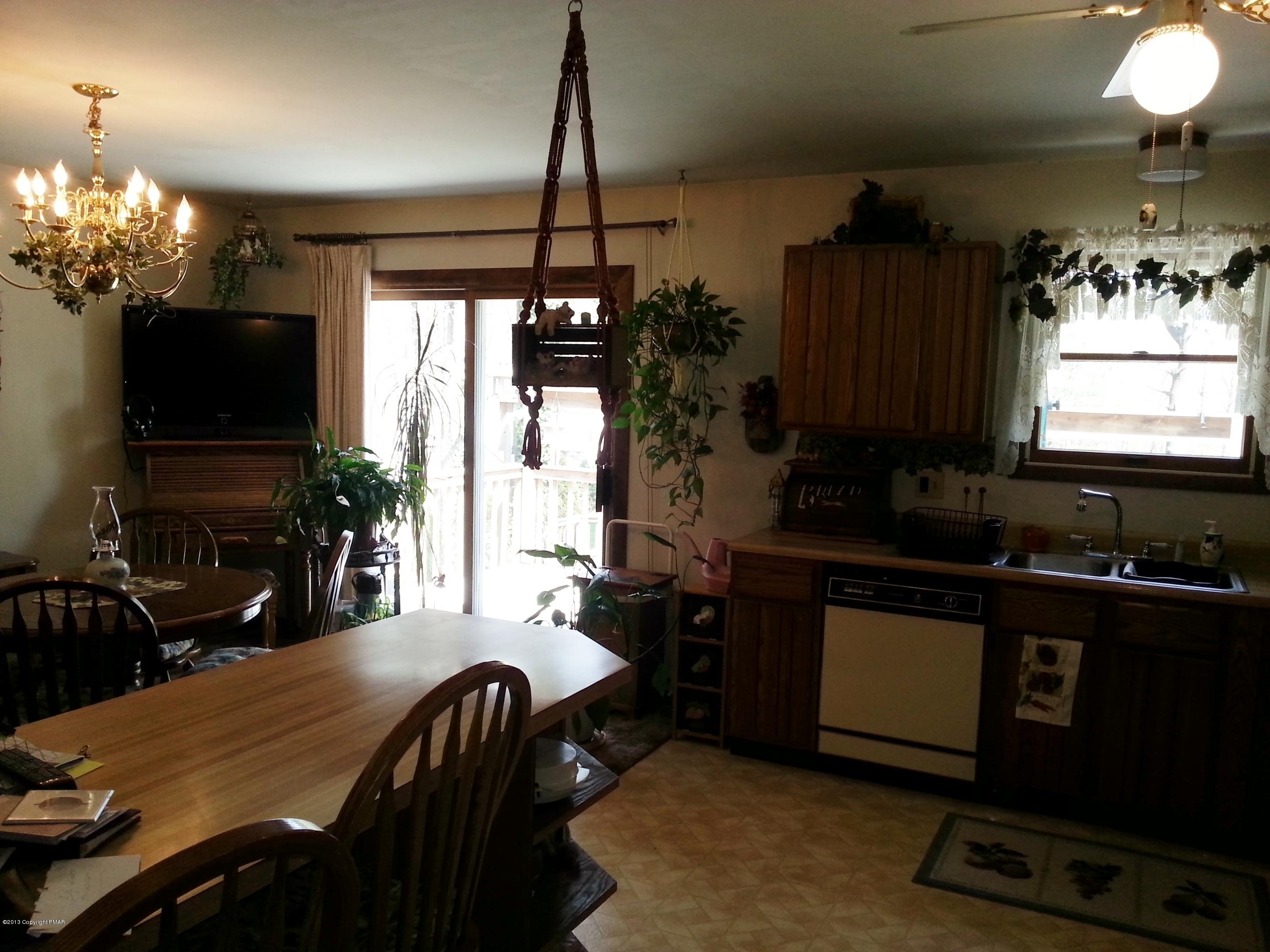2187 Shafer Road Stroudsburg, PA 18360 - Photo 7 of 29 a kitchen with sink table and chairs