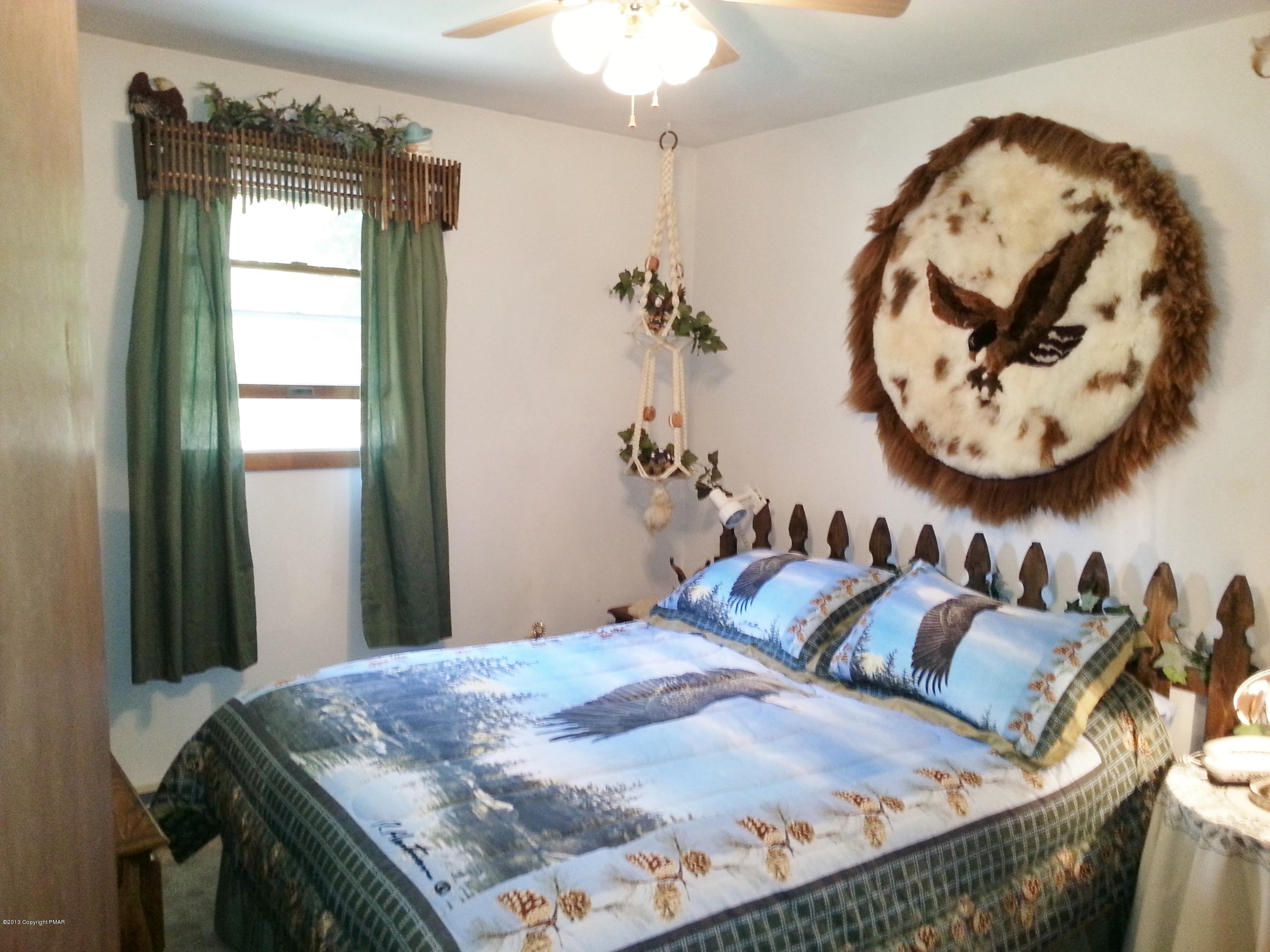 2187 Shafer Road Stroudsburg, PA 18360 - Photo 9 of 29 a bedroom with a bed and a table in it