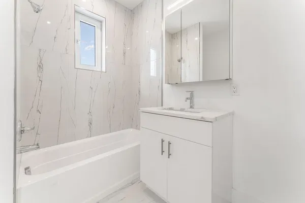 a bathroom with a bathtub and a sink