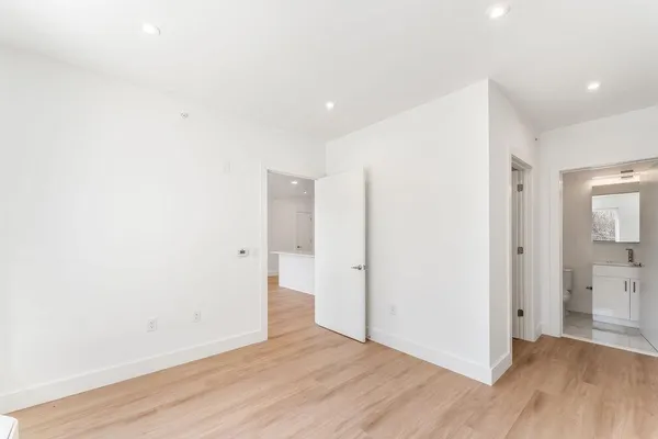 a view of an empty room with wooden floor
