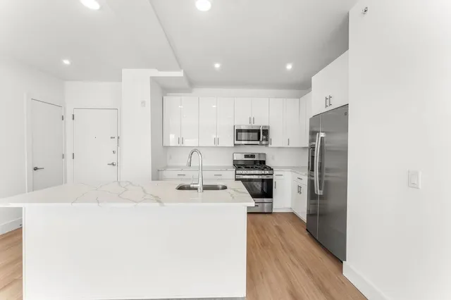 a kitchen with stainless steel appliances a refrigerator stove microwave and cabinets