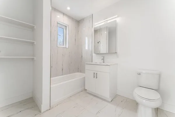 a bathroom with a toilet sink and bathtub
