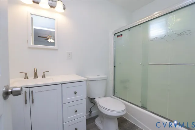a bathroom with a sink a toilet and vanity