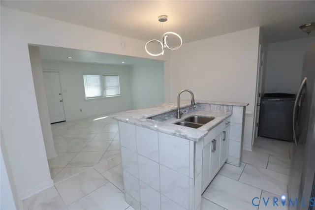 a utility room with a sink a washer and dryer