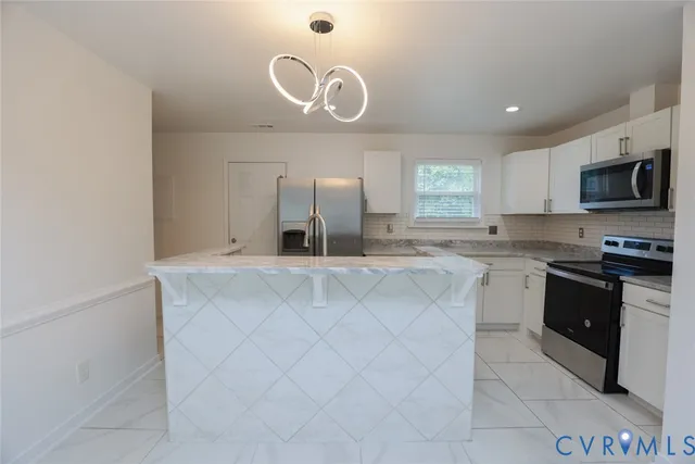 a kitchen with stainless steel appliances granite countertop a sink and a stove top oven with granite countertops