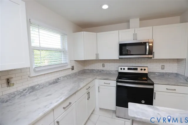 a kitchen with a sink stove top oven and microwave