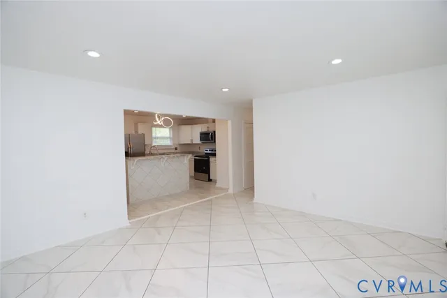 a view of kitchen with refrigerator and window