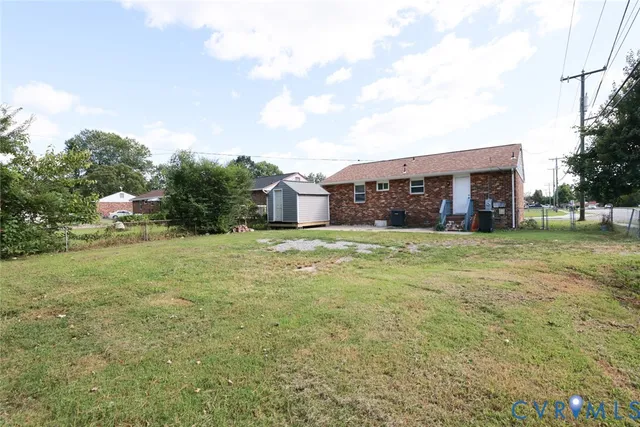 a view of a house with a yard and sitting area