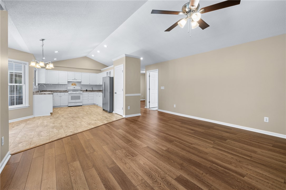 429 Burns Mill Road West Union, SC 29696 - Photo 10 of 49 An open-concept living space features vaulted ceilings, rich hardwood flooring, and a well-appointed kitchen.