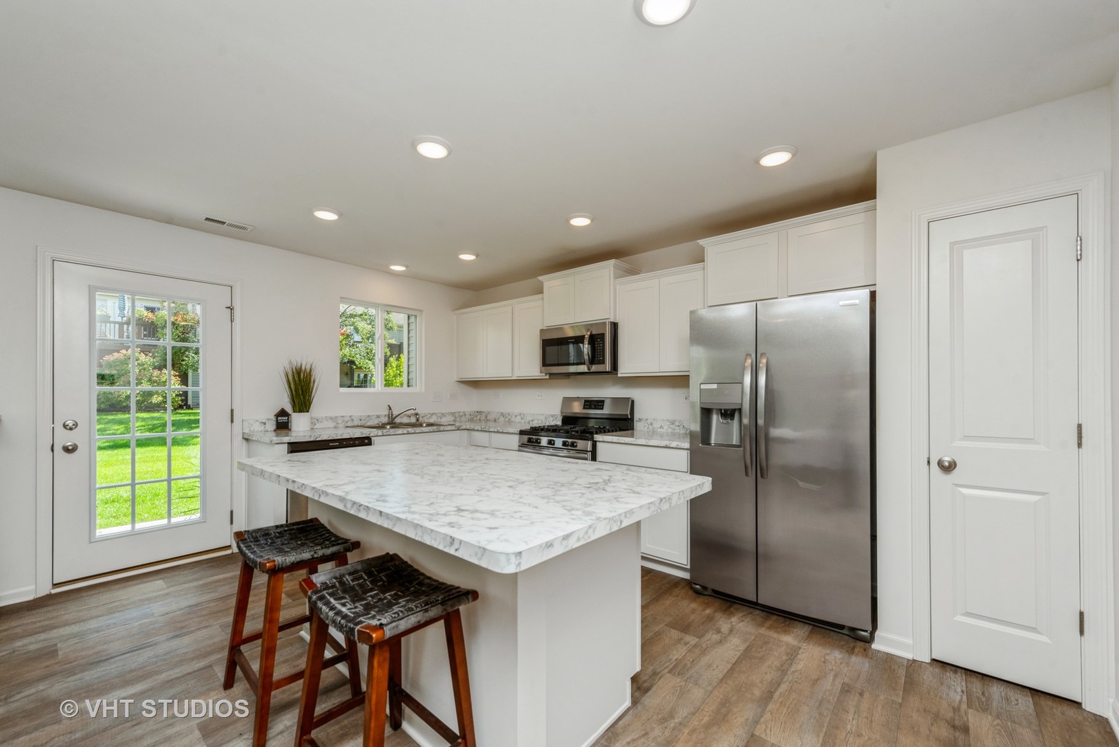 1205 Prairie View Parkway Cary, IL 60013 - Photo 3 of 14 a kitchen with stainless steel appliances granite countertop a refrigerator a sink a stove a dining table and chairs