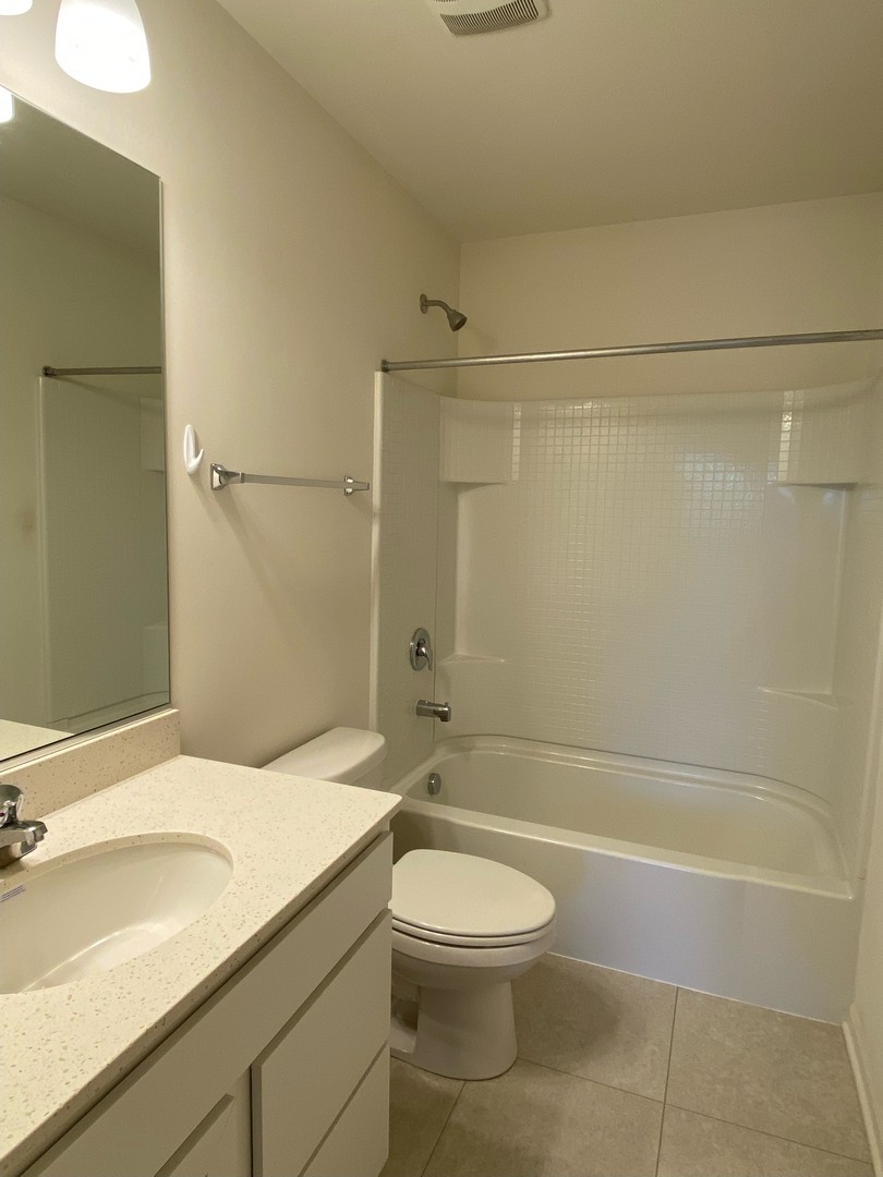 1205 Prairie View Parkway Cary, IL 60013 - Photo 8 of 14 a bathroom with a sink a toilet and shower