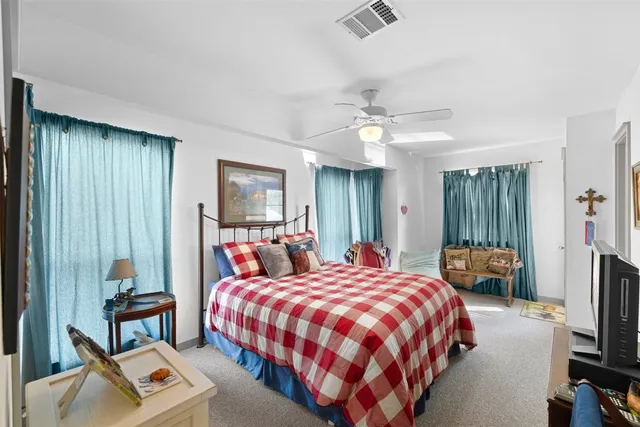 a bedroom with bed and a chandelier