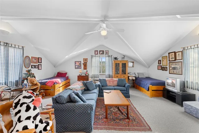 a living room with furniture fireplace and a window