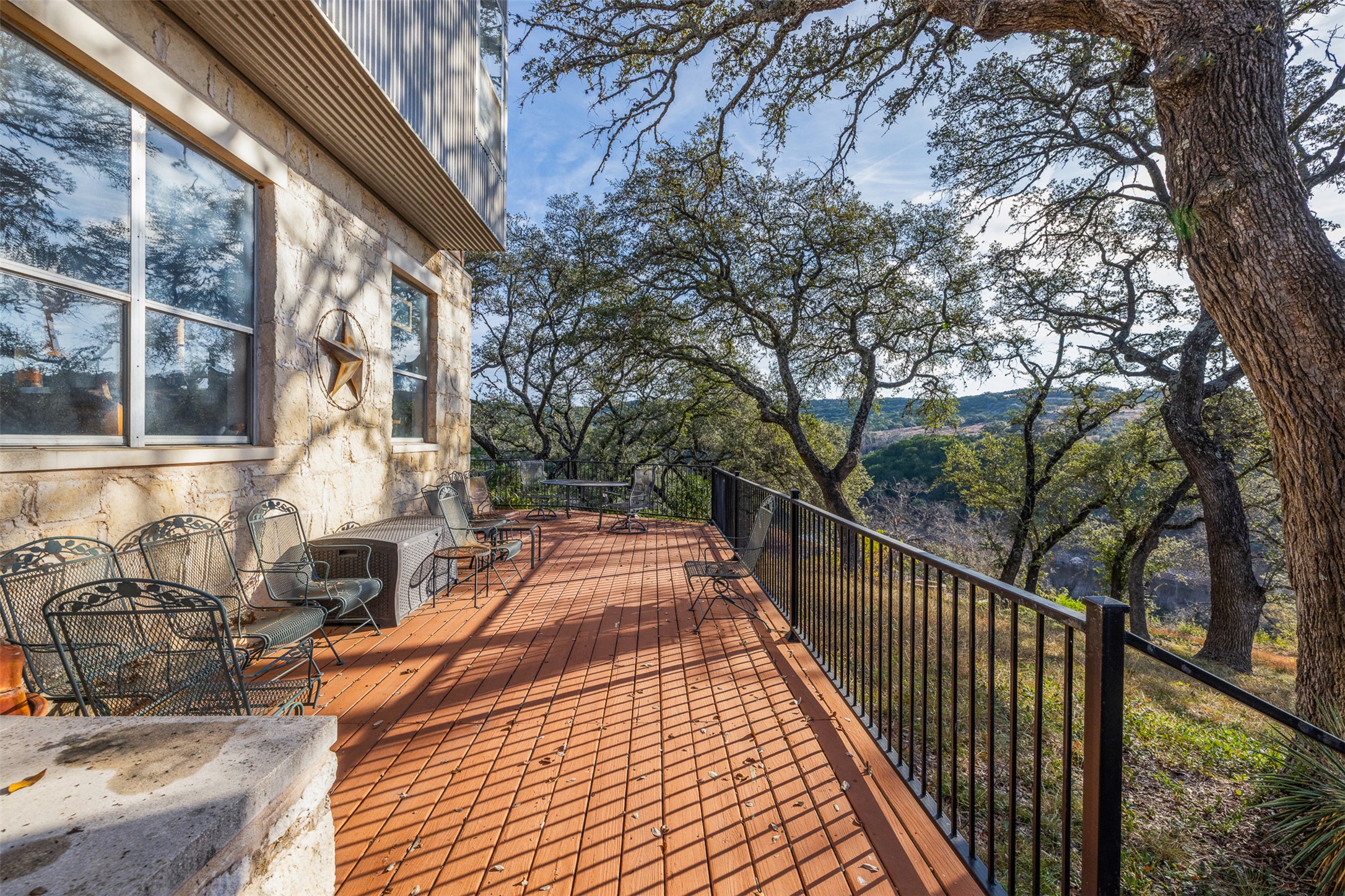27701 Turner Ranch Road Marble Falls, TX 78654 - Photo 14 of 40 a view of balcony with wooden floor and outdoor seating