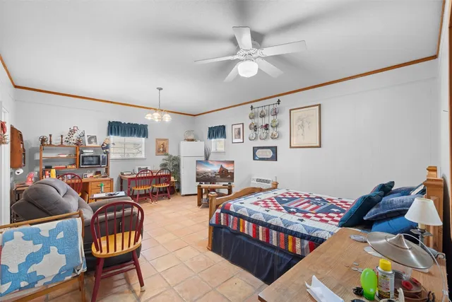 a bedroom with furniture and a chandelier