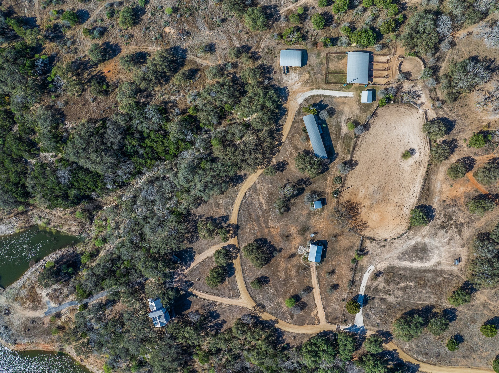 27701 Turner Ranch Road Marble Falls, TX 78654 - Photo 37 of 40 an aerial view of a house with a yard and large trees