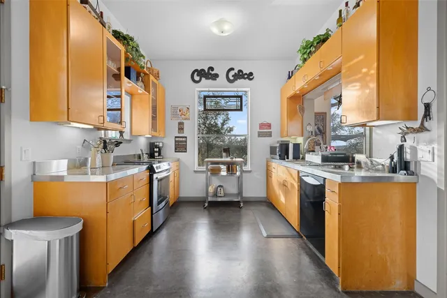 a kitchen with stainless steel appliances a stove top oven