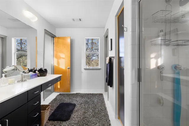 a bathroom with a sink a mirror and a shower