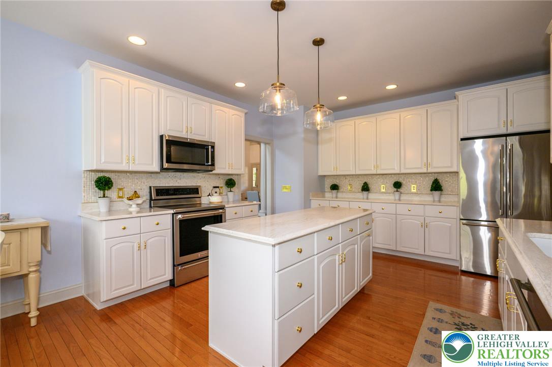217 Gower Road Nazareth, PA 18064 - Photo 18 of 44 A well-lit kitchen featuring white cabinetry and a generous center island, perfect for culinary endeavors.