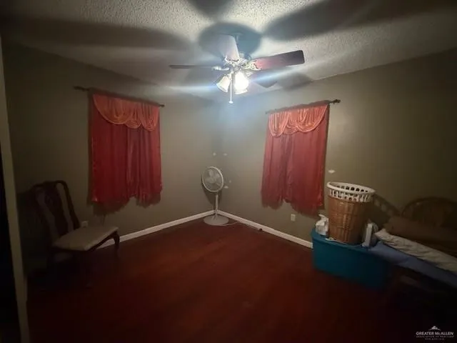 a view of a livingroom with furniture and chandelier fan