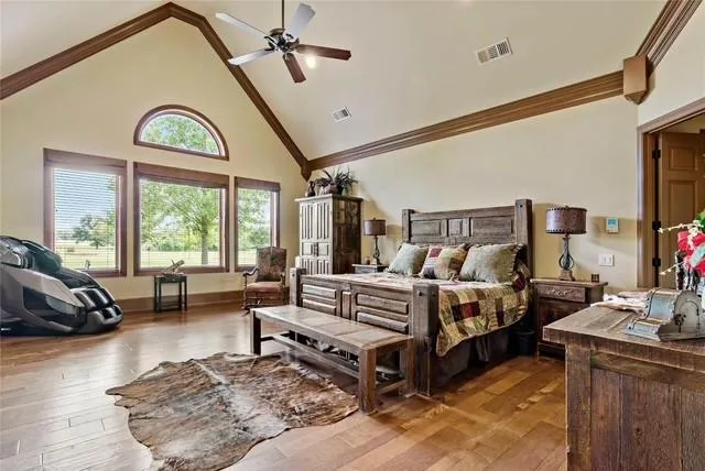 a spacious bedroom with a bed a couch and dresser