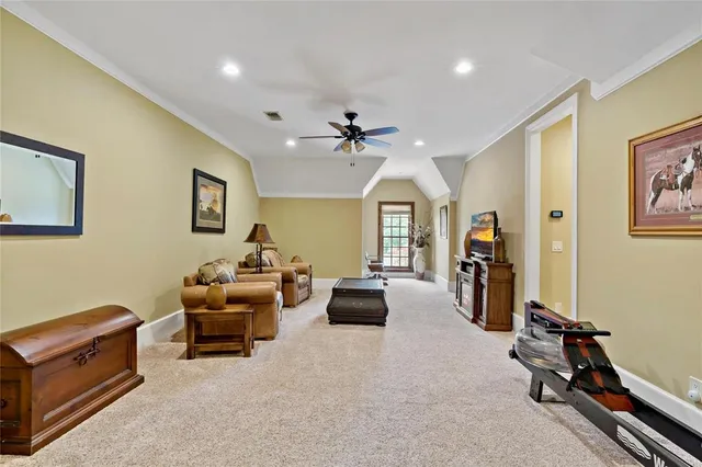 a living room with furniture gym equipment and a window