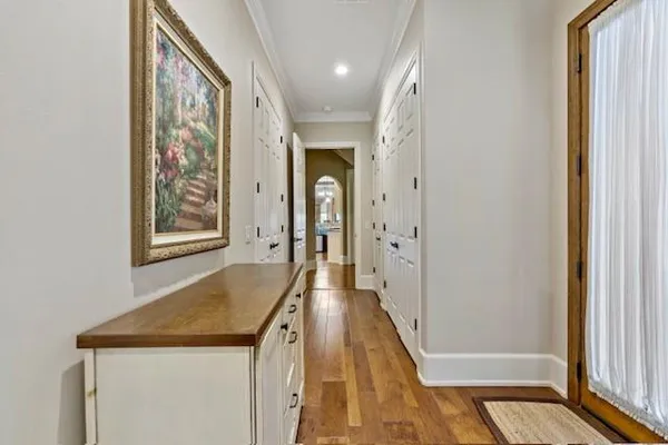 a view of a hallway with wooden floor and staircase