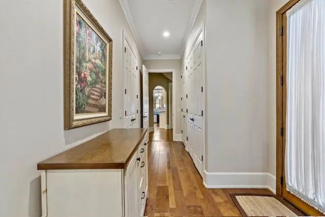 a view of a hallway with wooden floor and staircase