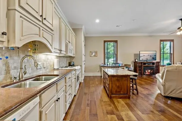 a kitchen with sink a counter space and dining table