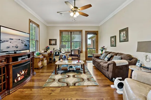 a living room with furniture flat screen tv and a fireplace