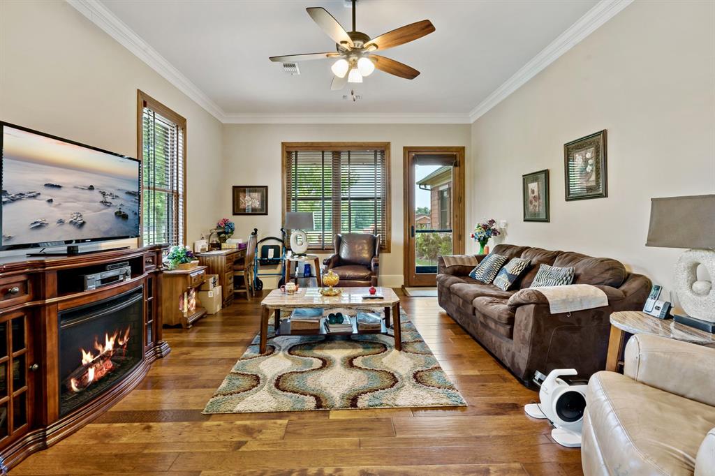 695 County Rd Road Honey Grove, TX 75446 - Photo 26 of 40 a living room with furniture flat screen tv and a fireplace