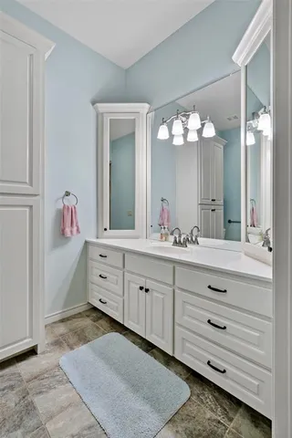 a bathroom with a sink vanity and mirror