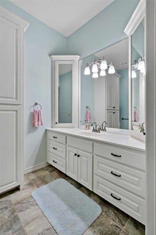 695 County Rd Road Honey Grove, TX 75446 - Photo 27 of 40 a bathroom with a sink vanity and mirror