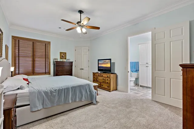 a bedroom with a bed and dresser